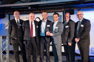 Property win - APAM accept the award for Fastest Growing Small Business from Paul Johnson of Ward Hadaway (left) Paul O'Halloran of MEN Media (right) and Greater Manchester Combined Authority chief executive Eamonn Boylan (second from right).