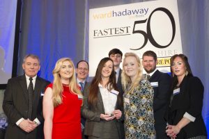 Fastest growing small company winners Pet Brands (front, from second left) Rachel Barrass, Charlotte Parker, Ben Ledgerd, Chelsea Reeves and Donna Hoyle receive their trophy from (left) Phil Jordan of Ward Hadaway (third from left) John Cridland of Transport for the North and (second from right) James Mitchinson of The Yorkshire Post.